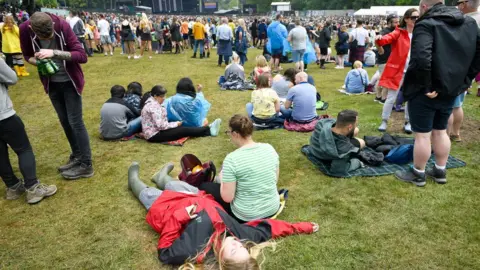 PA People relax away from the crowds during the first day of BBC Music's Biggest Weekend at Singleton Park, Swansea