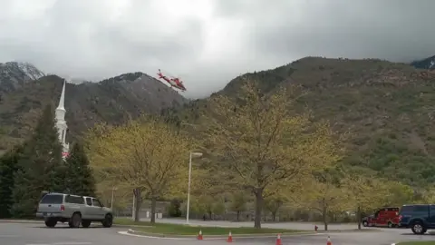 A rescue helicopter heads to Lone Peak in Utah