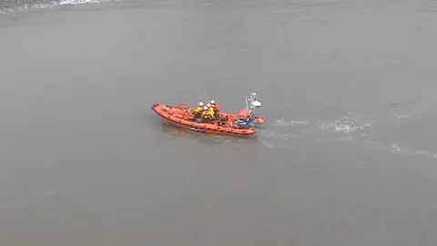 An aerial view of coastguards in action