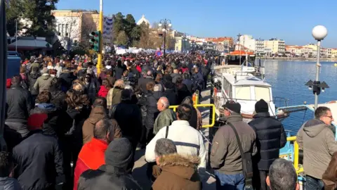 Protesters gathered along the seafront in Lesbos's coastal capital Mytilene