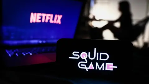 NurPhoto Netflix and Squid Game logos