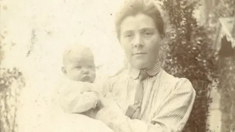 RHS Lindley Collections Olive with her son, John, in a garden