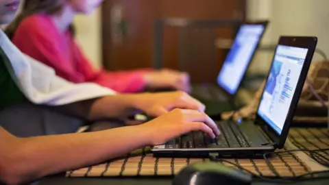 Getty Images Stock image of children using laptops