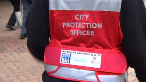 BBC Back of person wearing City Protection Officer jacket