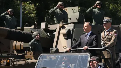 EPA-EFE/REX/Shutterstock The Polish army Chief of General Staff, Gen Rajmund Andrzejczak (right) and Polish President Andrzej Duda (2nd right) during a military parade in Warsaw. Photo: 15 August 2023