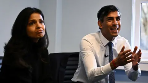 Reuters British Prime Minister Rishi Sunak (R) and his wife Akshata Murty