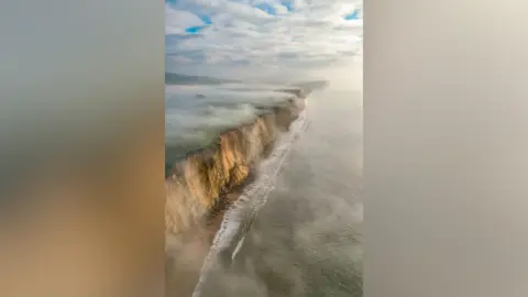 Winter mist rolling over cliffs has won the South West Coast Photographer of the Year 2025.