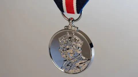 PA Media A 'thank you' medal to be given to frontline workers by the King to mark the Coronation. On one side can be seen a profile view of the King and Queen Consort.