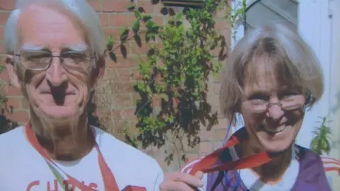 Family photo Chris and Charm after completing the London Marathon in 2012