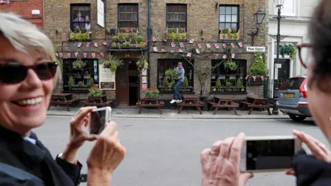 AFP Flowers are hung outside a pub, covered in Union flag-themed bunting near Windsor Castle in Windsor