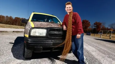 Wade Payne/Guinness World Records Tami Manis next to her truck
