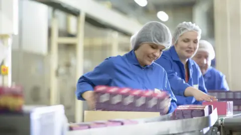 Getty Images Women in biscuit factory