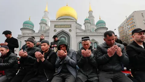 EPA Worshippers praying outside Central Sobornaya Mosque, Moscow Russia