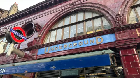 BBC/Harry Low London Underground roundel and signage above Tube station entrance