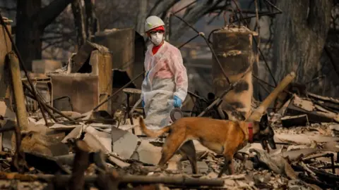 Getty Images search crews look for fire victims