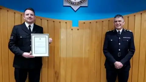 Avon and Somerset Police Chief Constable Andy Marsh presents Sgt Wright with his commendation