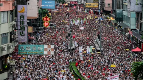 Getty Images Thousands of protesters take part in a march against amendments to an extradition bill in Hong Kong