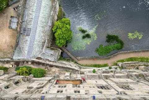 Jacob King / PA Media Cleaners abseil down the walls of Warwick Castle