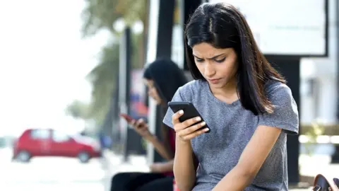 Getty Images Woman using mobile phone