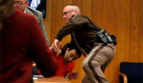 Reuters Court security staff try to shield Larry Nassar after the father of three of his victims lunged at him