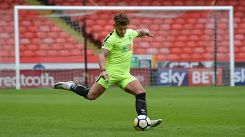 Thetford Town FC Matt Morton playing on the pitch