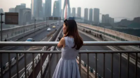 Getty Images A young lady enjoys the view of the Yangtze river in Chongqing on May 31, 2017