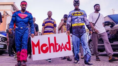 BBC/Adekola Olawale MohBad fans dressing in superhero outfits arrive at a memorial concert in Lagos, Nigeria - Thursday 21 September 2023