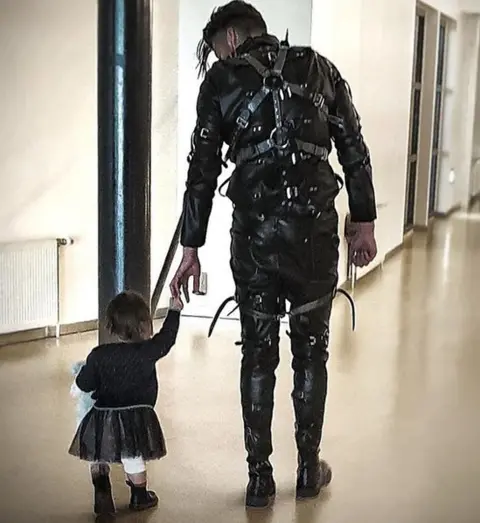 Guðmundur Atli A band member walks with a child after their winning performance in Iceland