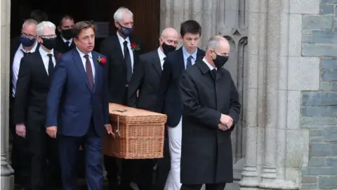 PA Media The casket of the former SDLP leader is carried by his son, John Hume Junior, and other family members.