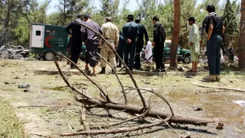 EPA Afghan security officials inspect the site of a suicide bomb blast near the Kabul Bank branch in Lashkar Gah, capital of Helmand province, Afghanistan, 22 June 2017.