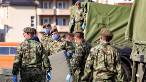 Getty Images Soldiers prep a filed hospital in Novi Pazar