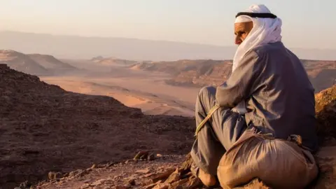 A tribesman of the Garasha looks over the rugged deserts of the Alegat