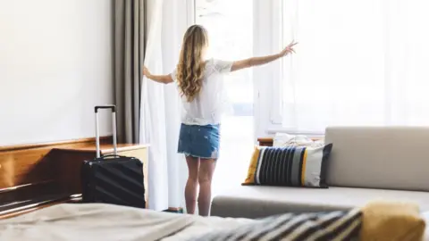 Getty Images Woman in hotel room