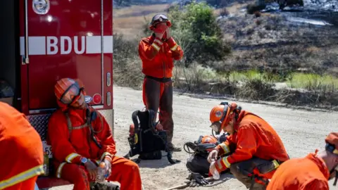 Getty Images Prado fire crews take a break from the 105 degree heat