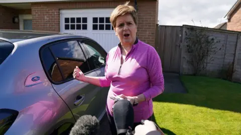 PA Media Nicola Sturgeon spoke briefly to reporters outside her home in Uddingston, Glasgow, on Friday