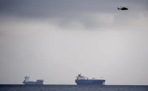 EPA Helicopters search Copenhagen harbour for a missing submarine