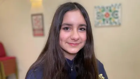 Valeria has long dark hair