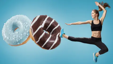 Getty Images Woman kicking doughnuts