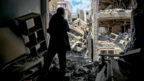 Photo from inside a house across a targeted residential building shows extensive damage in Tehran, Iran, on June 13, 2025.