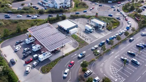 Getty Images Vehicles queue for fuel at a Sainsbury's petrol station in Weymouth, England