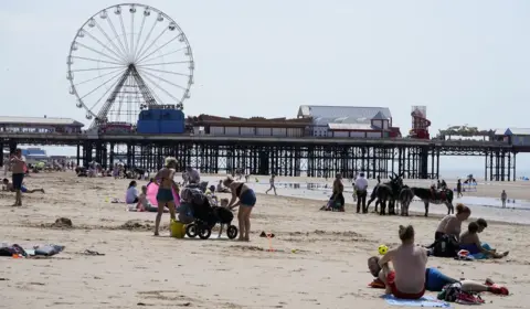 PA Media People enjoying the hot weather on Blackpool beach