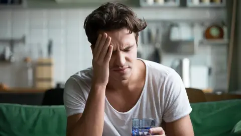 Getty Images A man with a headache