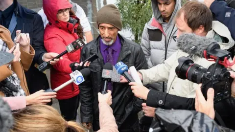 Getty Images Omar Nabi speaking to reporters outside the Christchurch court