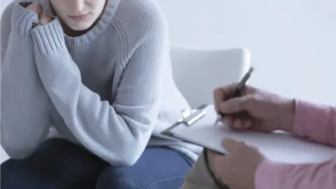 Getty Images Woman with doctor