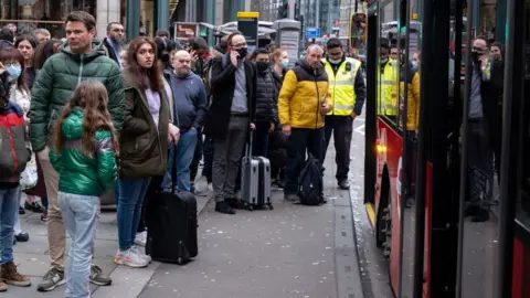 Getty Images People queuing for a bus