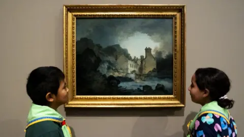 Jordan Pettitt/PA Wire Two young scouts stand either side of the painting The Rising Squall in an art gallery. The picture depicts a very grey, atmospheric, stormy day on the River Avon looking across towards a large stone building