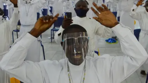 Getty Images Worshippers wearing facemask sings as worship centers reopen after the COVID-19 lockdown, at the Celesitail Church of Christ, Arch Diocese National Headquarter Makoko, Lagos, as measures against the spread of COVID-19 Coronavirus in Lagos, Nigeria on August 8, 2020