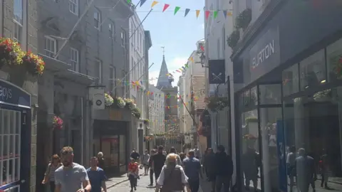 BBC St Peter Port high street with people shopping