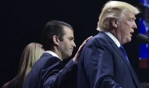 AFP/Getty Images Donald Trump, Jr places a hand on the shoulder of his father, Donald Trump, during a rally on the final night of the 2016 US presidential election