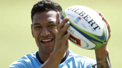 EPA Israel Folau smiles as he catches a rugby ball